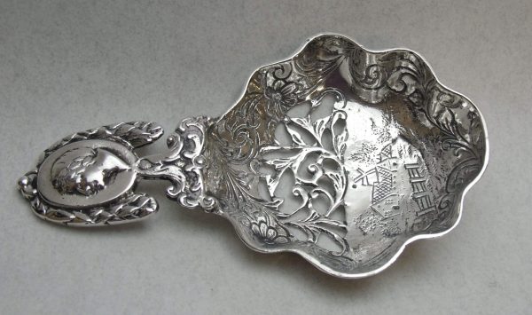 Imported silver caddy spoon with elaborate decoration