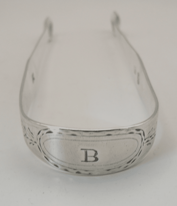 Bright cut engraved decoration on a Set of Hester Bateman silver sugar tongs