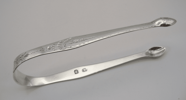 Bright cut engraved decoration on a Set of Hester Bateman silver sugar tongs