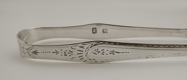 Bright cut engraved decoration on a Set of Hester Bateman silver sugar tongs