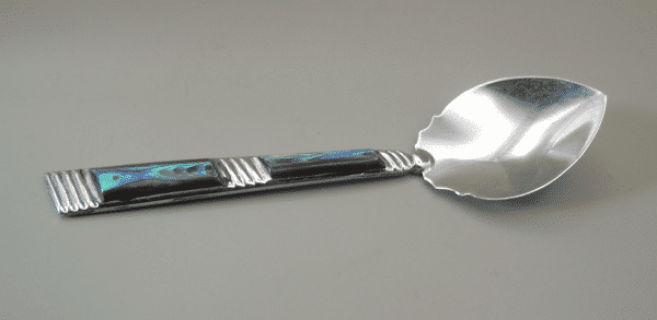 A Sterling Silver spoon with abalone shell decoration