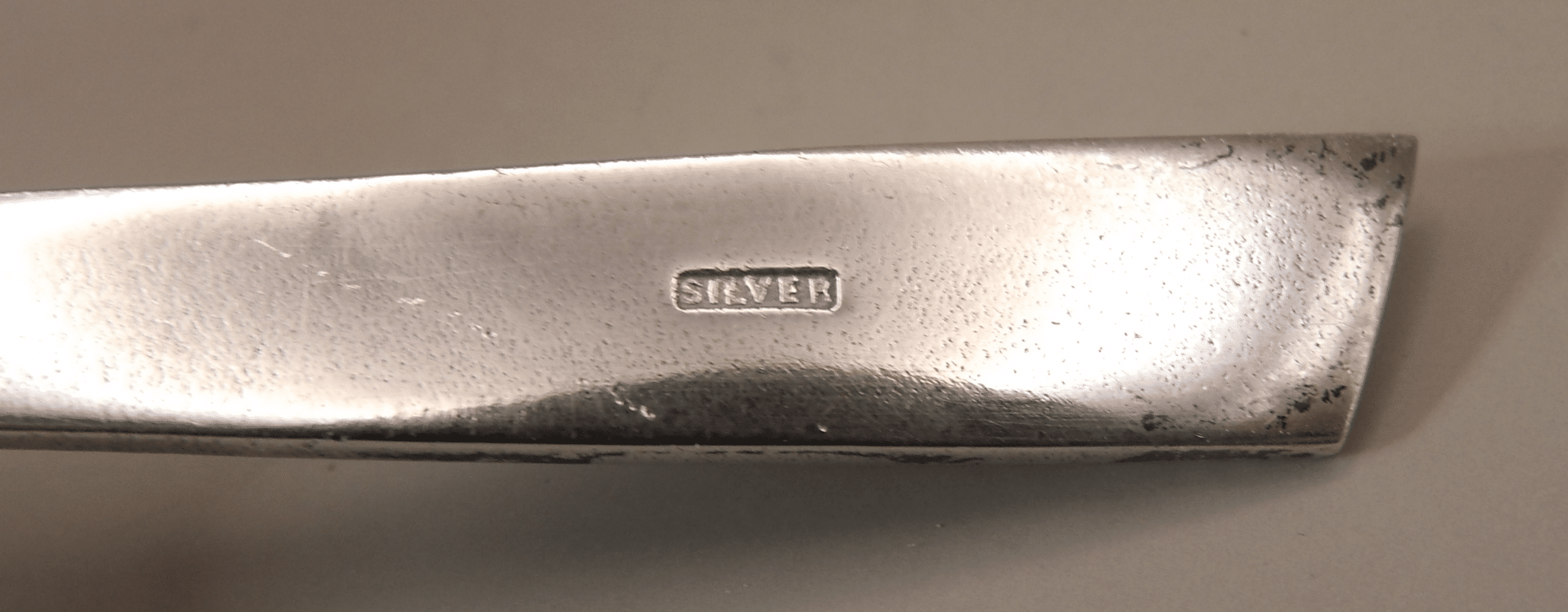 A Sterling Silver spoon with abalone shell decoration